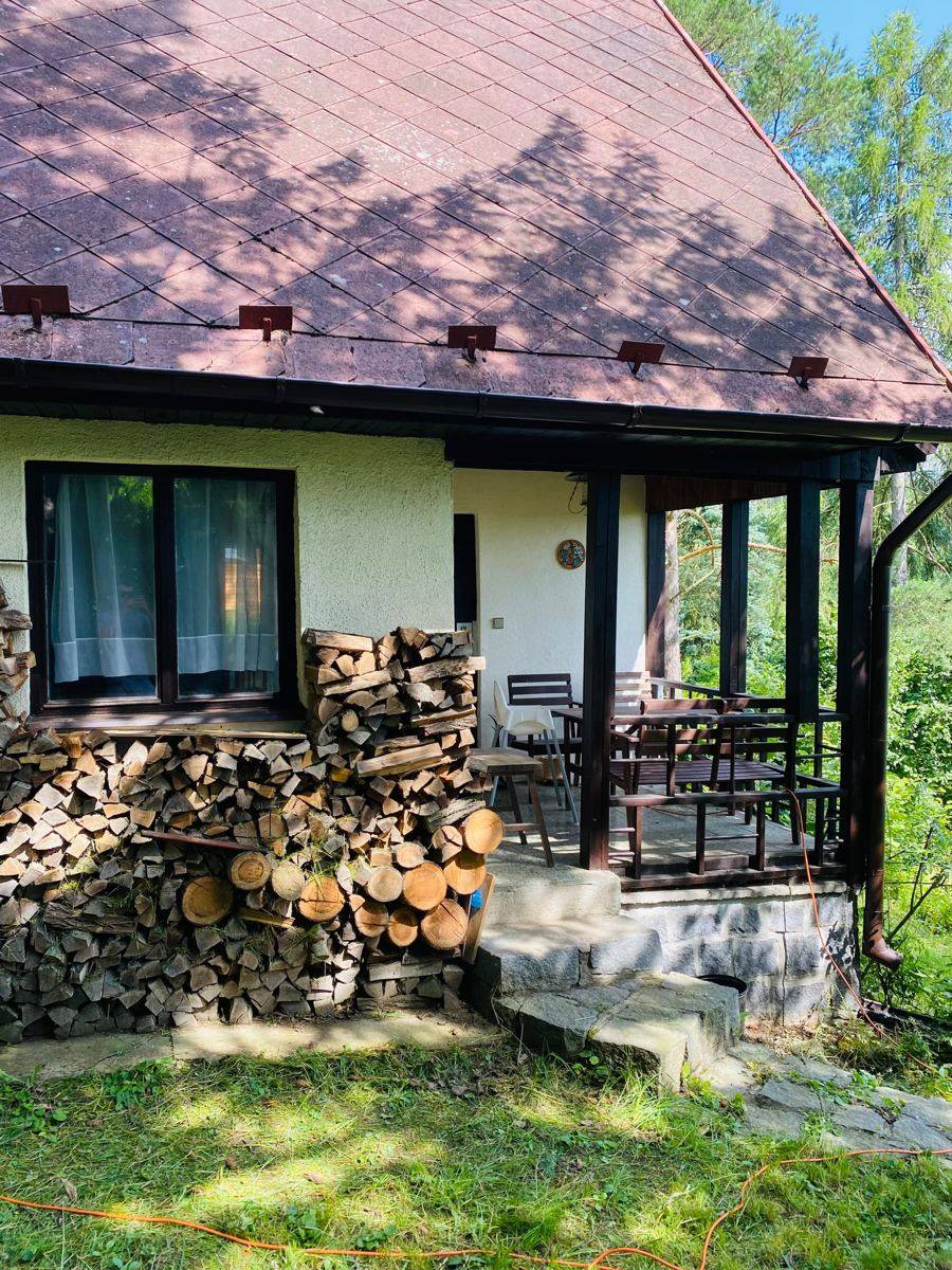 Terasa pod střechou, vedle naskládané dřevo